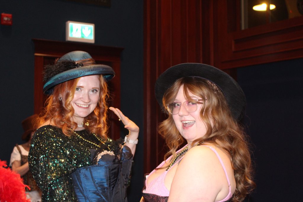 Two event attendees posing in corsets