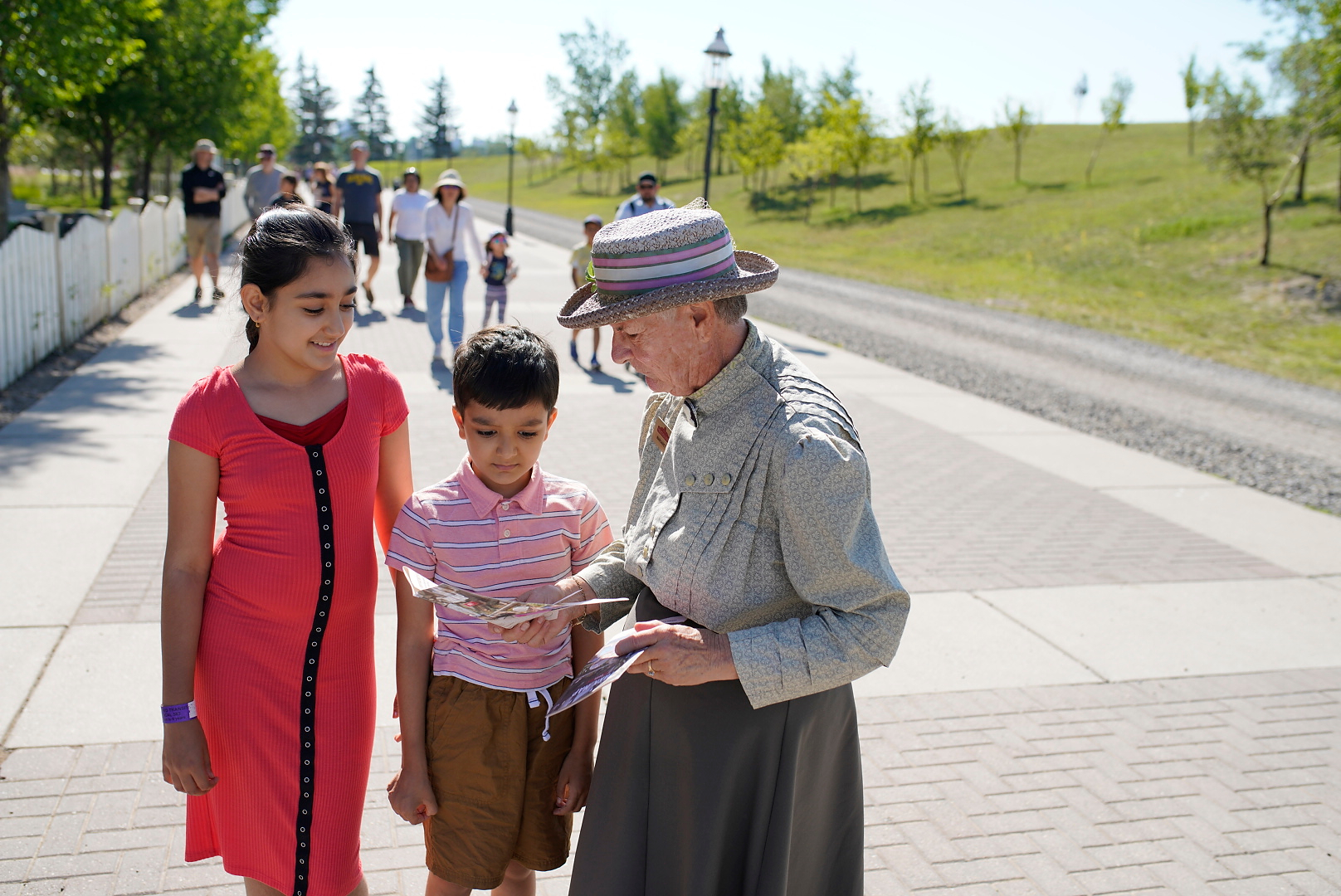 An interpreter shows the map to two young visitors at Heritage Park