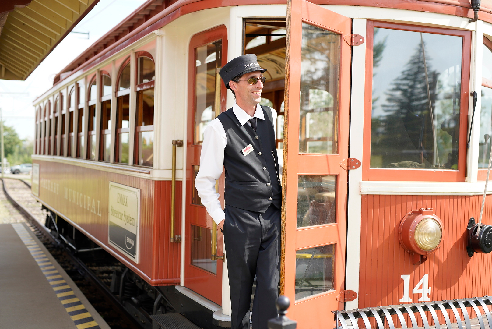Man standing next to the streetcar at Heritage Park