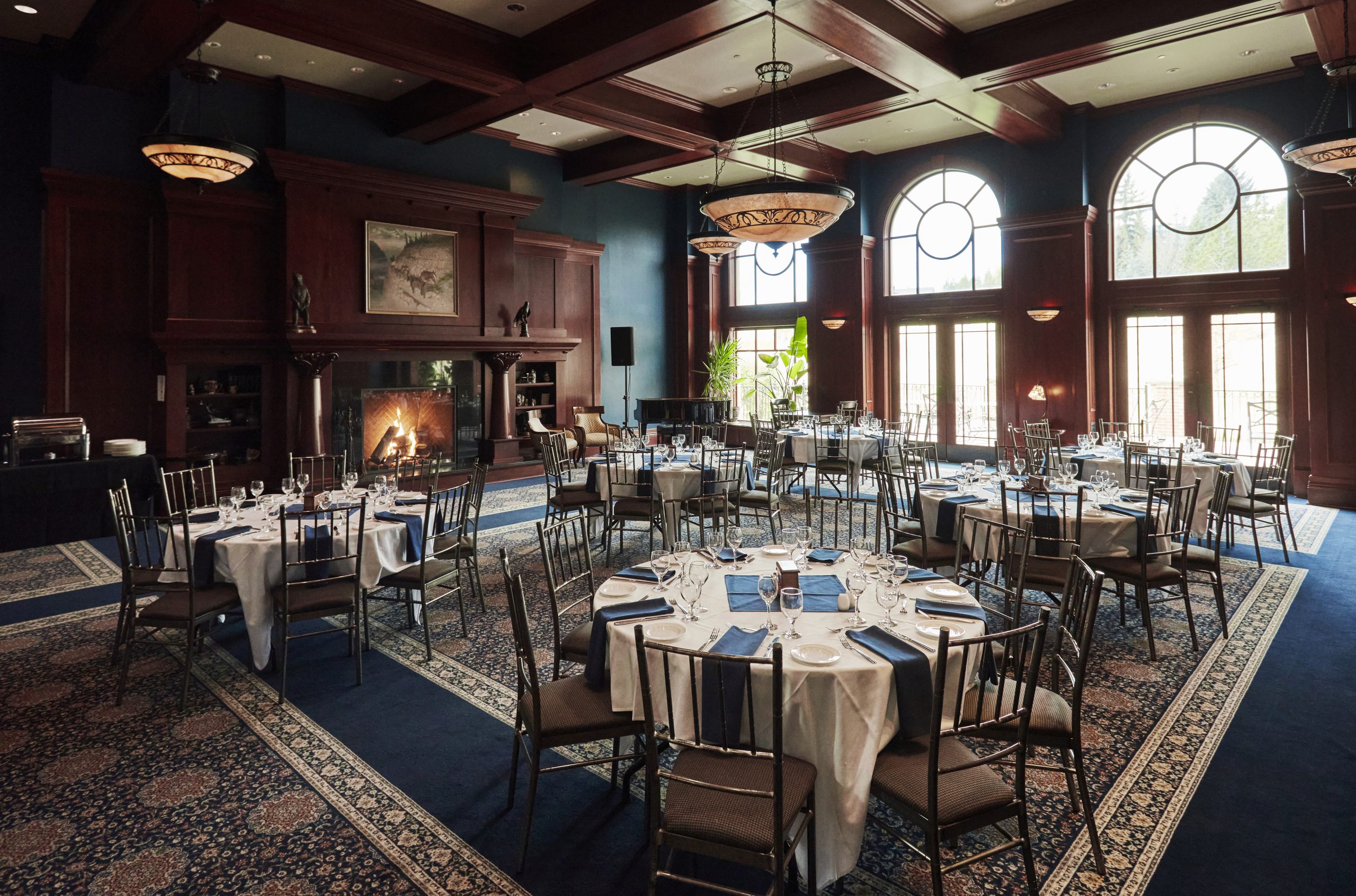 The Founder's Lounge at Heritage Park set up with round tables for a private dinner party