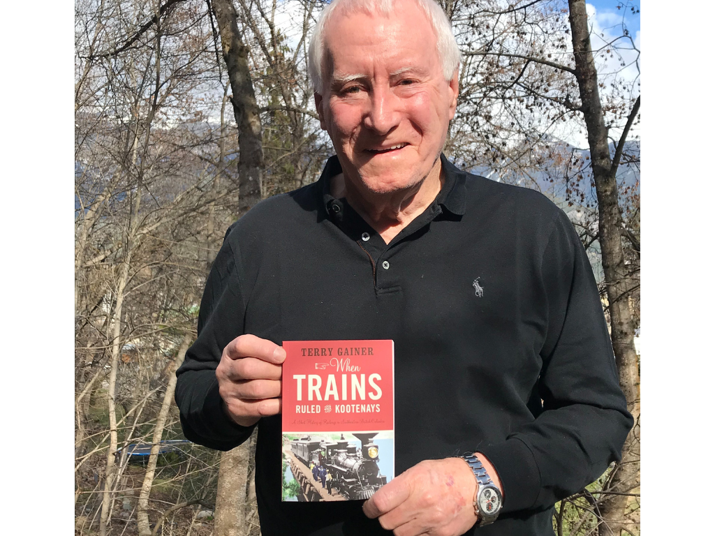 Terry Gainer displaying his book