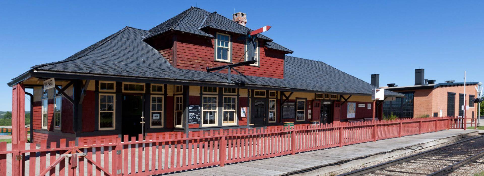 red and black train station with train tracks 