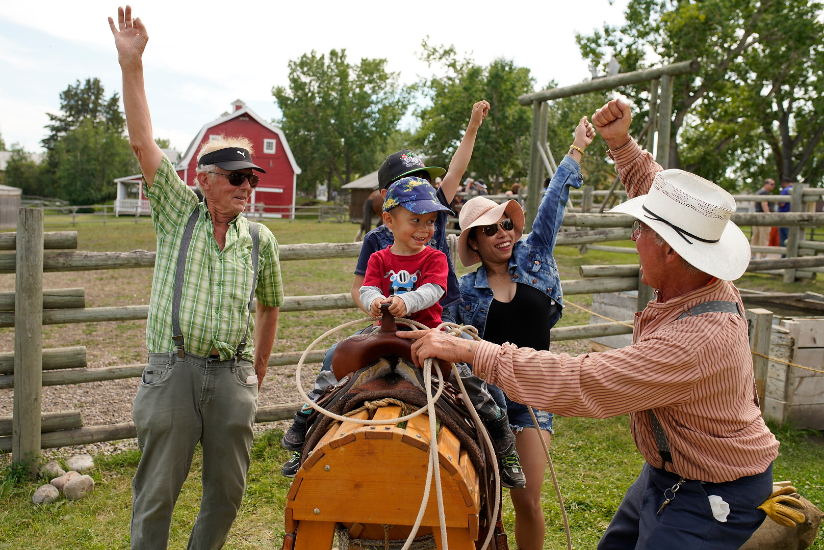 A family has fun learning to rope in the Agriculture Area of Heritage Park's Historical Village in Calgary