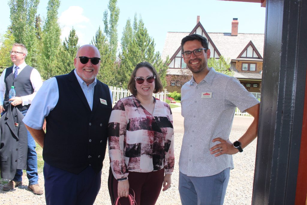 Heritage Park's COO and CCO, Kevin Graham and Philip Calvert, standing with a Heritage Park supporter.
