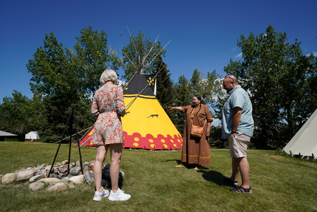 Indigenous interpreter interacts with Heritage Park guests